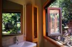Bathroom looks out to a rocky backdrop.