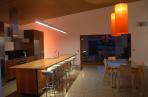 Lighting enhances the kitchen as dusk falls.