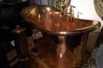 Gleaming copper bathtub in the Hansgrohe bathroom museum.