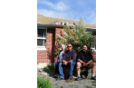 Landlords June Peka and son Dino Peka, with tenant Bryan Constable, outside their ruined rental home in Avonside.