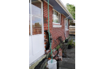Exterior wall caved inwards; a giant hole opened up under the house.