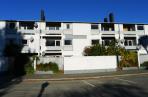 Oxford Terrace: Classic Warren & Mahoney concrete-block building has structural cracks; demolished.